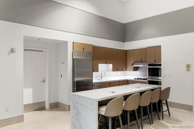 a kitchen with kitchen island a sink stove and refrigerator