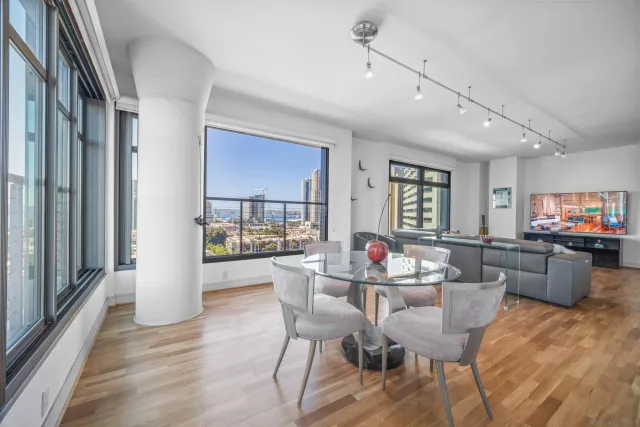 a dining room with furniture and wooden floor