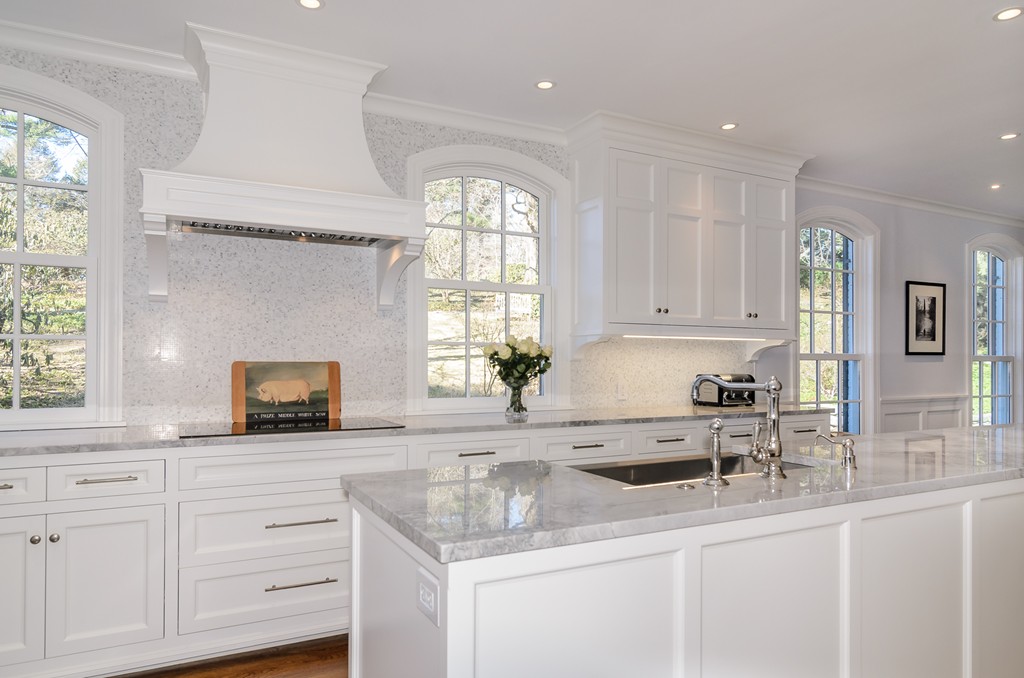 21 Carisbrooke Road Wellesley, MA 02481 - Photo 3 of 18 a kitchen with granite countertop white cabinets white appliances a sink and a window