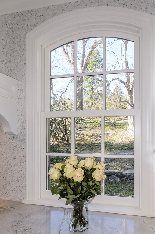 21 Carisbrooke Road Wellesley, MA 02481 - Photo 6 of 18 a vase of flowers sitting on a window sill