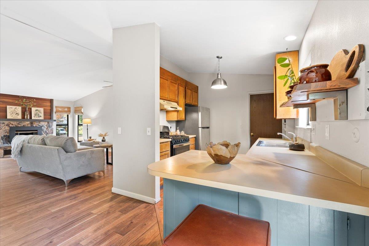 561 Blight Road Grass Valley, CA 95945 - Photo 13 of 44 a kitchen with kitchen island a stove and a sink