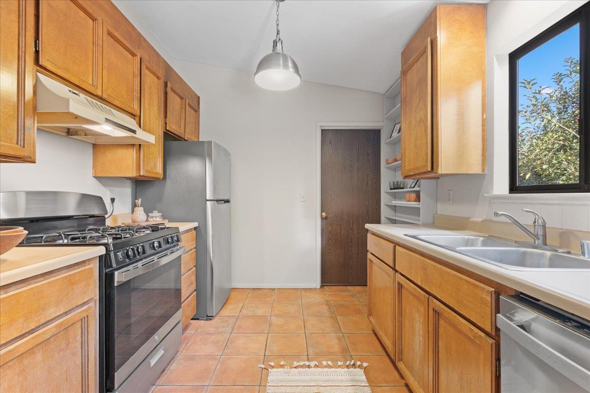 561 Blight Road Grass Valley, CA 95945 - Photo 14 of 44 a kitchen with a stove a sink and a refrigerator