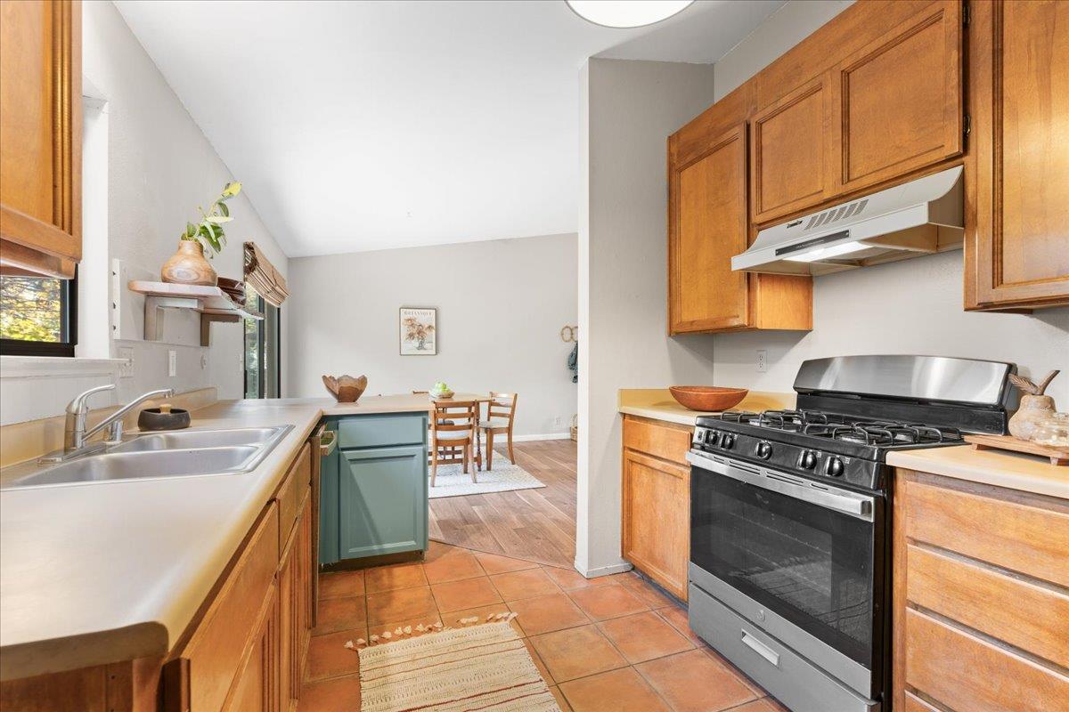 561 Blight Road Grass Valley, CA 95945 - Photo 15 of 44 a kitchen with stainless steel appliances granite countertop a stove a sink and a microwave