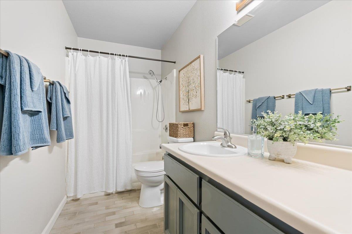 561 Blight Road Grass Valley, CA 95945 - Photo 20 of 44 a bathroom with a sink a toilet and a mirror
