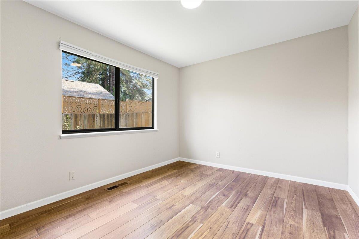 561 Blight Road Grass Valley, CA 95945 - Photo 23 of 44 a view of an empty room with wooden floor and a window