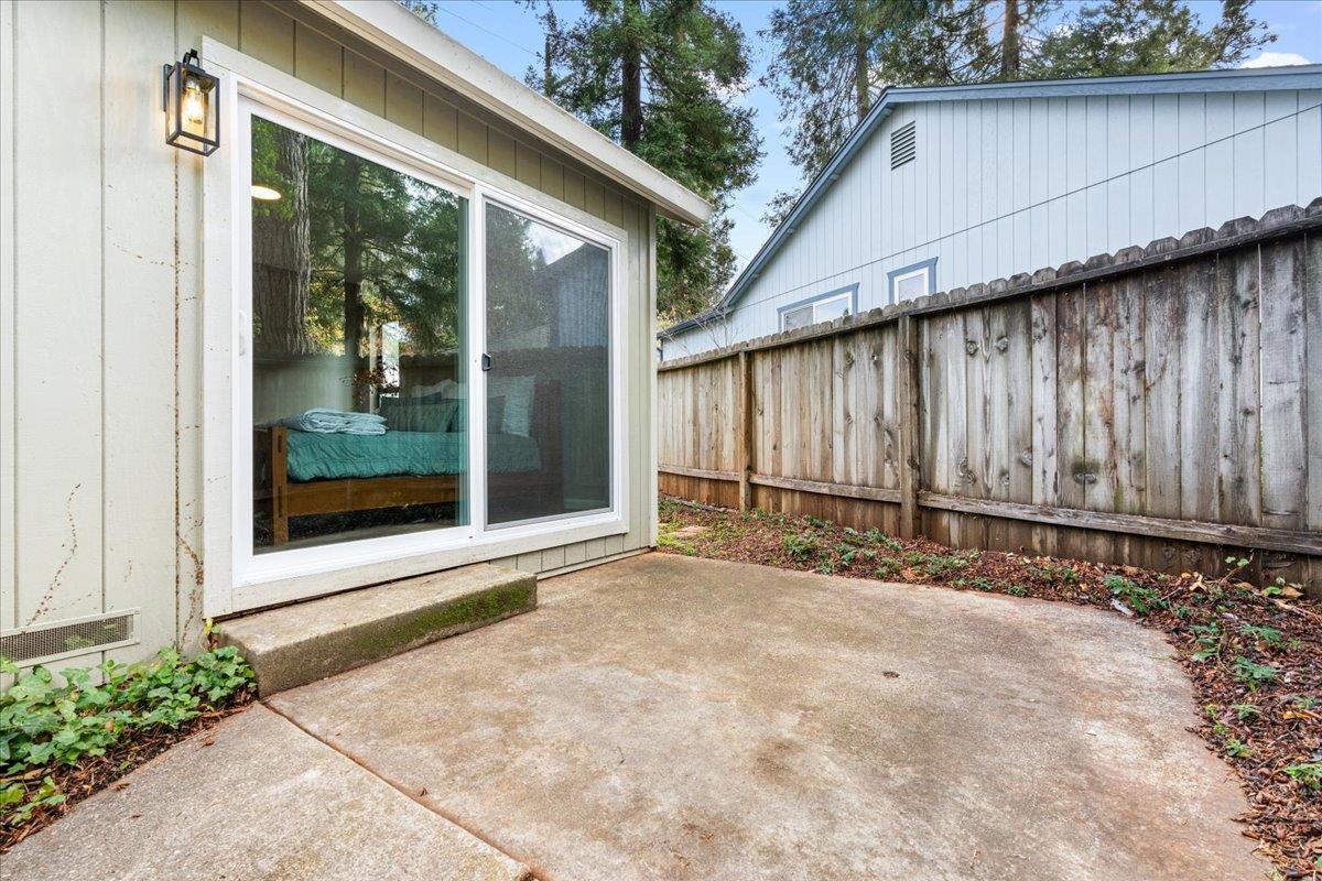 561 Blight Road Grass Valley, CA 95945 - Photo 29 of 44 a view of a backyard with blue fence and a large tree