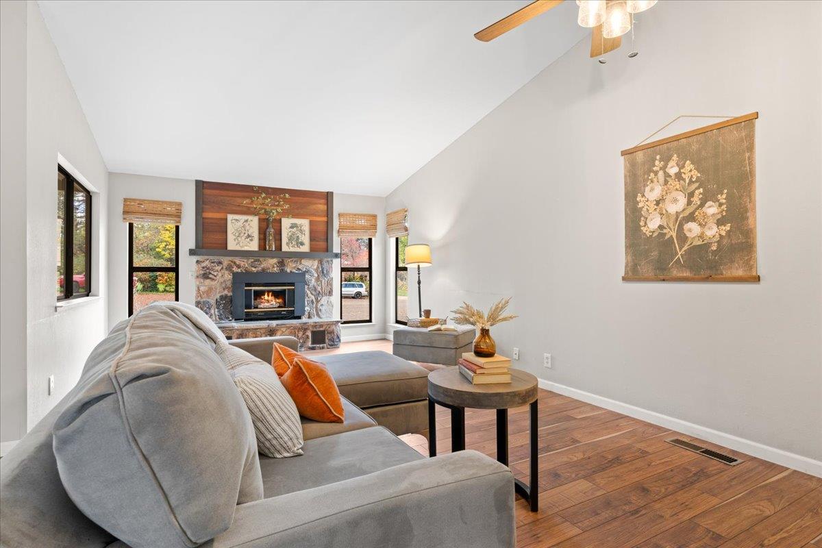 561 Blight Road Grass Valley, CA 95945 - Photo 9 of 44 a living room with furniture a fireplace and a chandelier