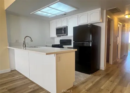 a kitchen with a refrigerator sink and microwave