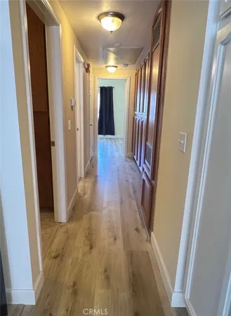 a view of hallway with wooden floor