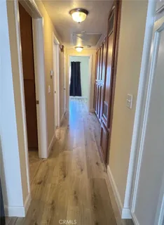 a view of hallway with wooden floor