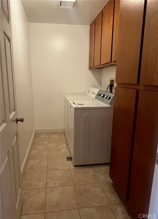 a view of a storage and utility room with a refrigerator
