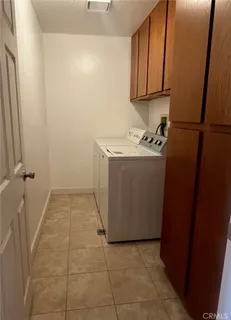 a view of a storage and utility room with a refrigerator