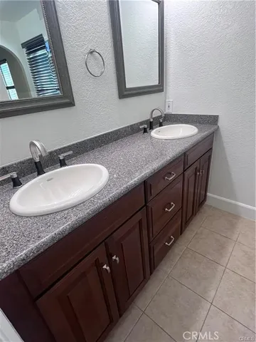 a bathroom with a granite countertop sink a mirror and a vanity