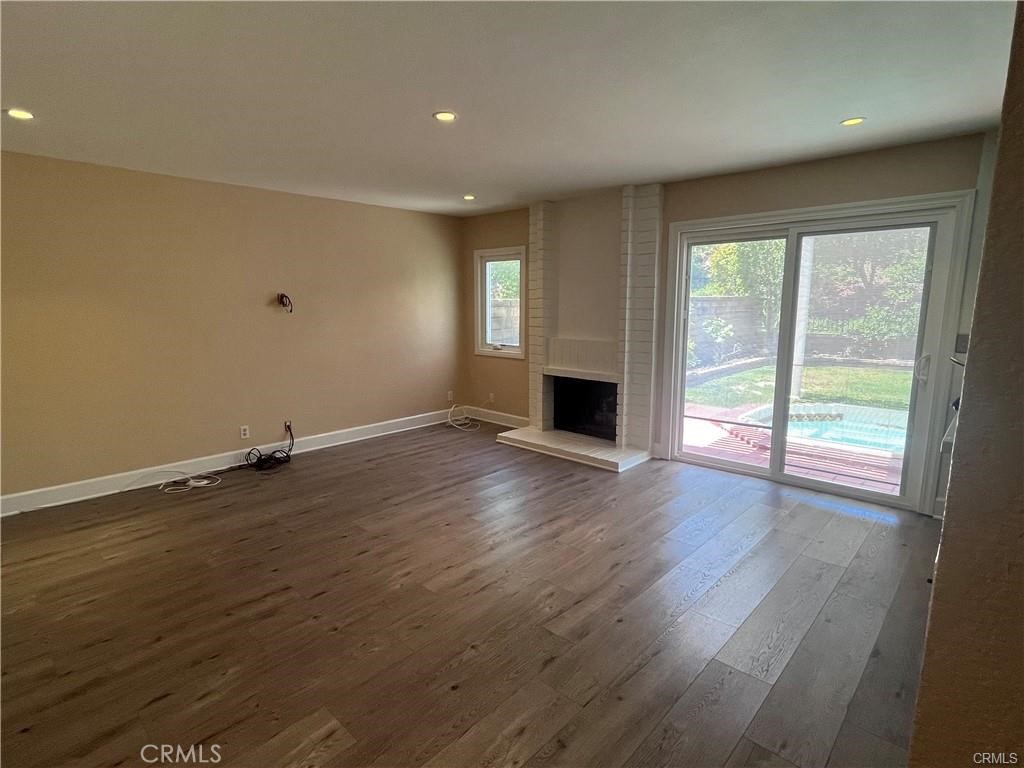 21681 Cabrosa Mission Viejo, CA 92691 - Photo 4 of 22 an empty room with wooden floor and windows