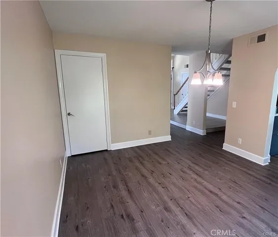 a view of a room with wooden floor and staircase