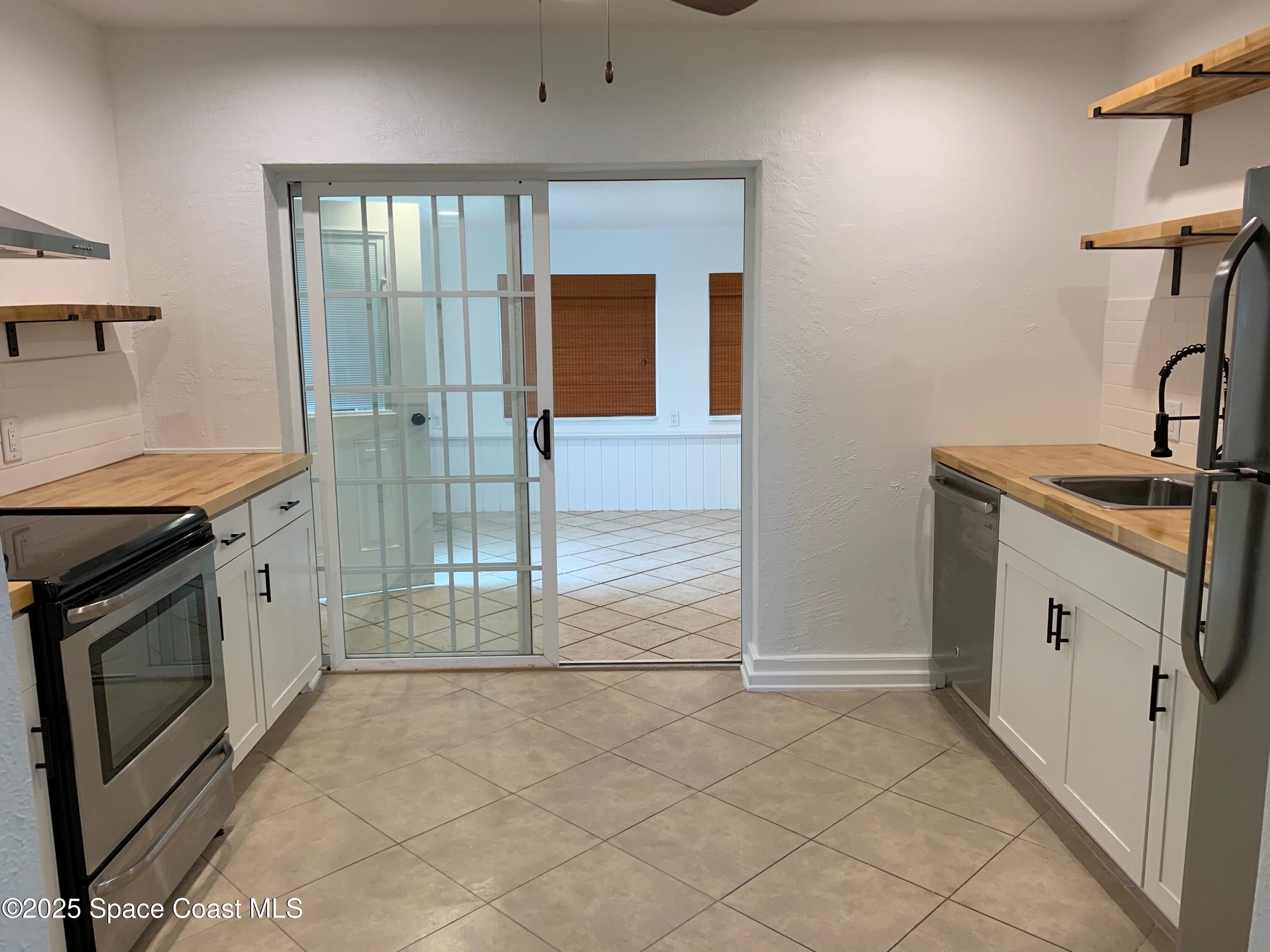 110 Del Flora Indialantic, FL 32903 - Photo 11 of 33 a kitchen with a sink stove and cabinets