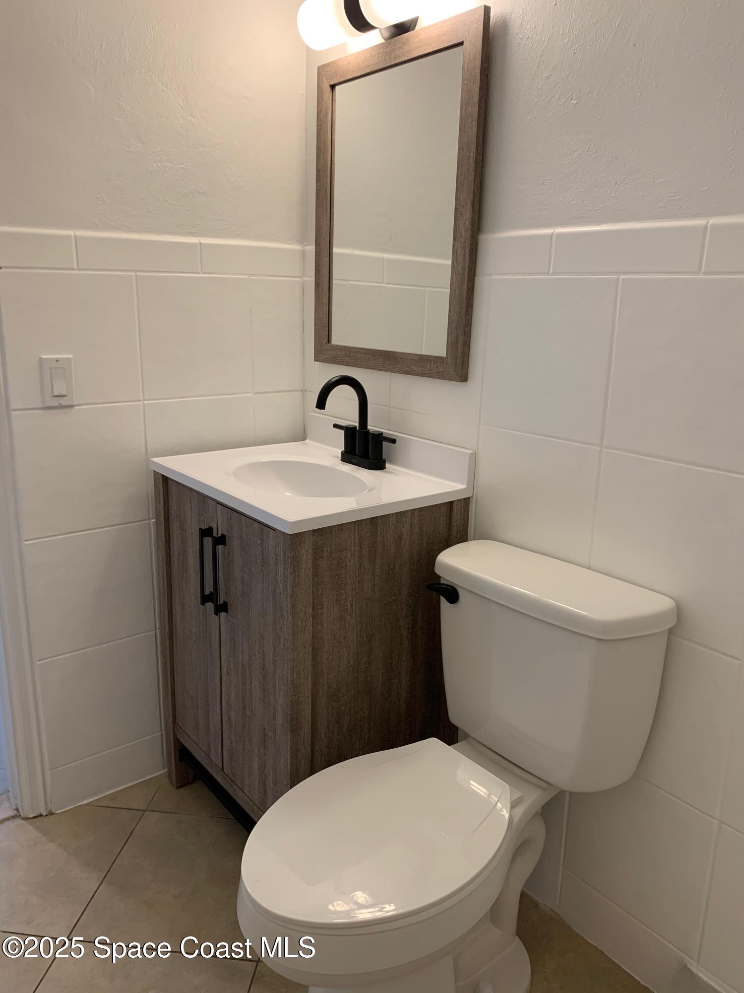 110 Del Flora Indialantic, FL 32903 - Photo 18 of 33 a bathroom with a toilet a sink and mirror