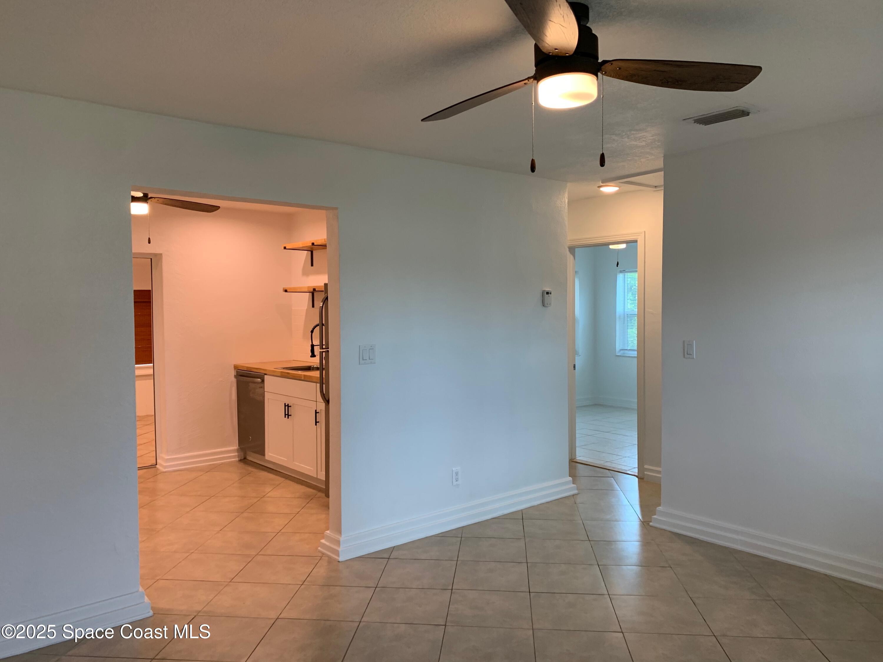 110 Del Flora Indialantic, FL 32903 - Photo 7 of 33 a view of a livingroom with a chandelier fan and refrigerator