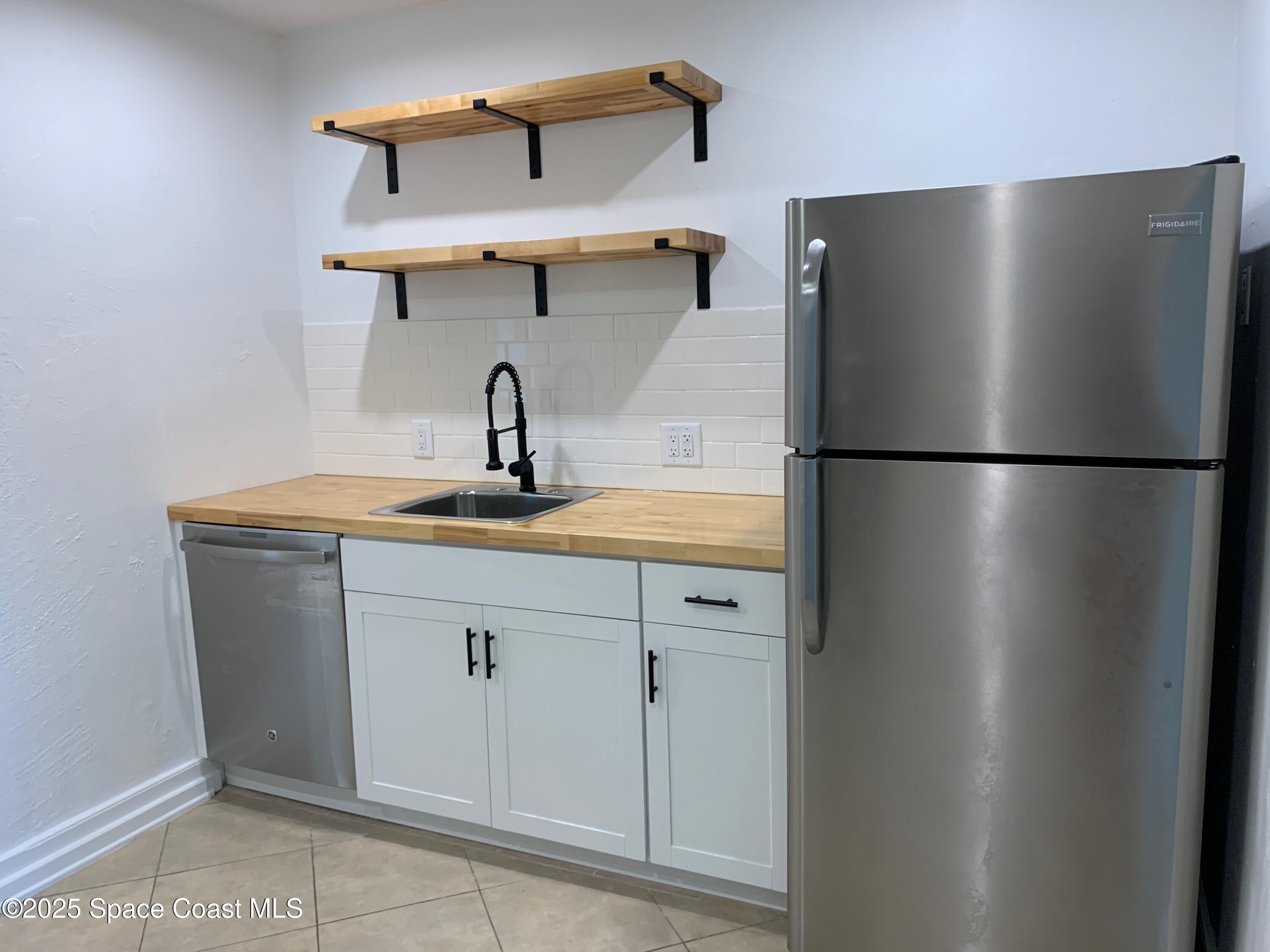 110 Del Flora Indialantic, FL 32903 - Photo 9 of 33 a kitchen with a refrigerator and a sink