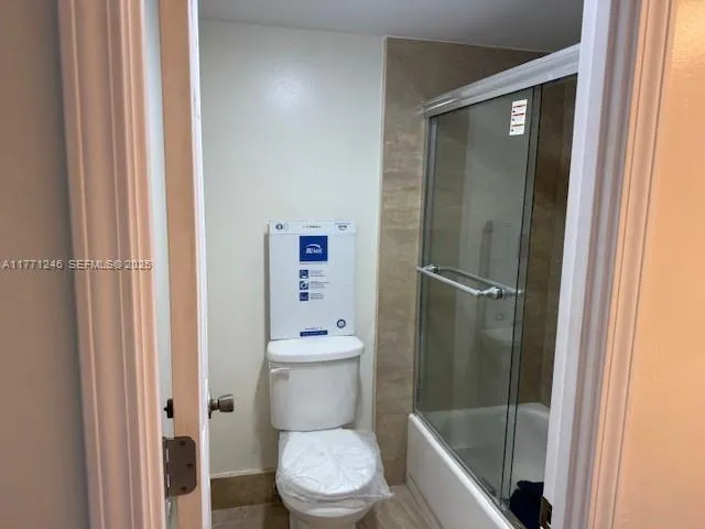 a white toilet sitting next to a bathroom sink