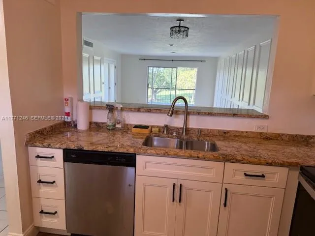 a kitchen with cabinets appliances and a window
