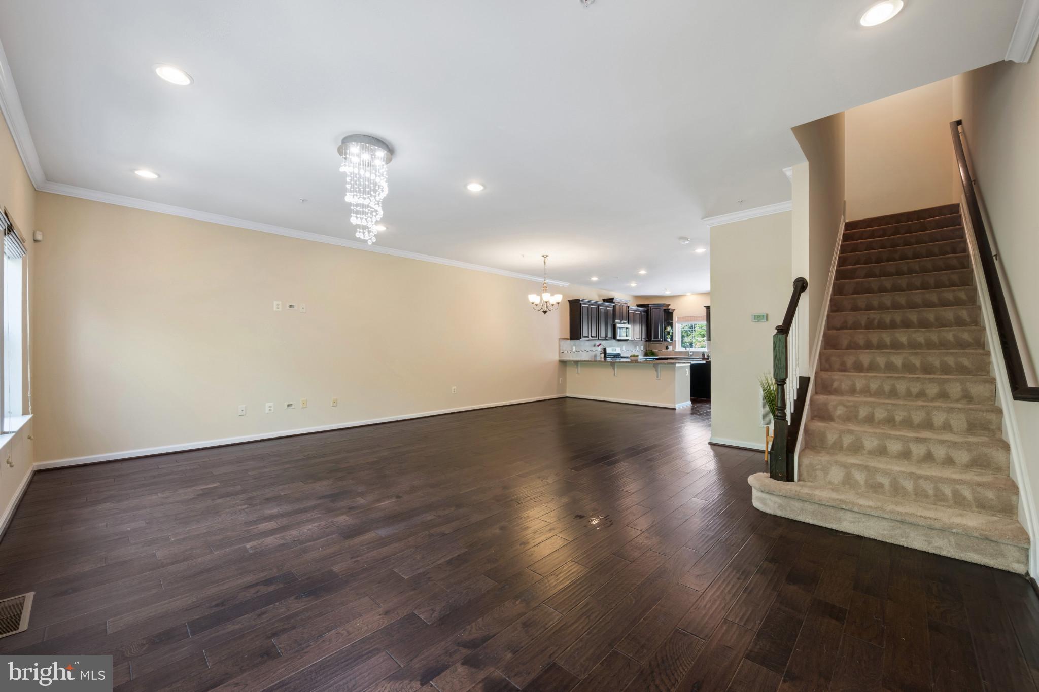 7062 Foxton Way Hanover, MD 21076 - Photo 17 of 41 an empty room with wooden floor and stairs