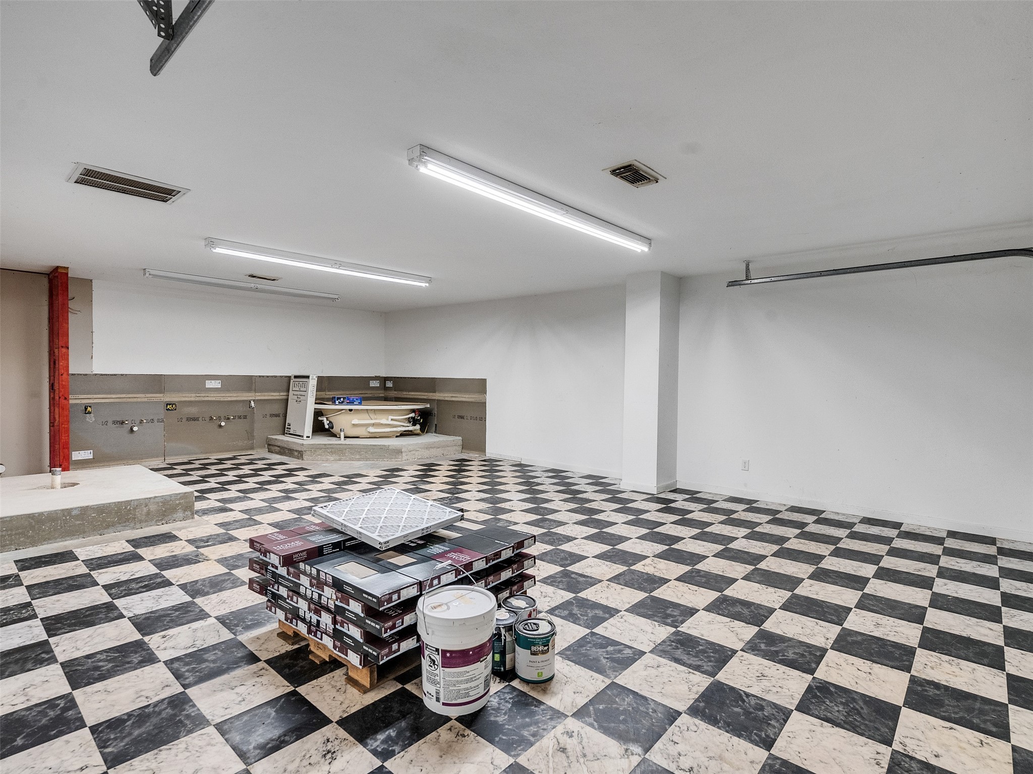 7301 Pearson Road Santa Fe, TX 77517 - Photo 28 of 46 a kitchen with a checkered floor and white cabinets