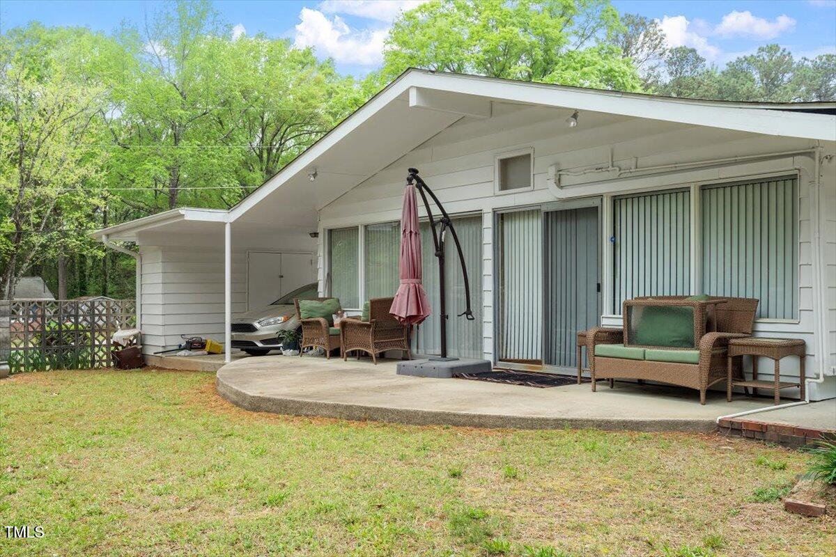 911 Williams Road Raleigh, NC 27610 - Photo 11 of 33 a view of a house with backyard sitting area and garden