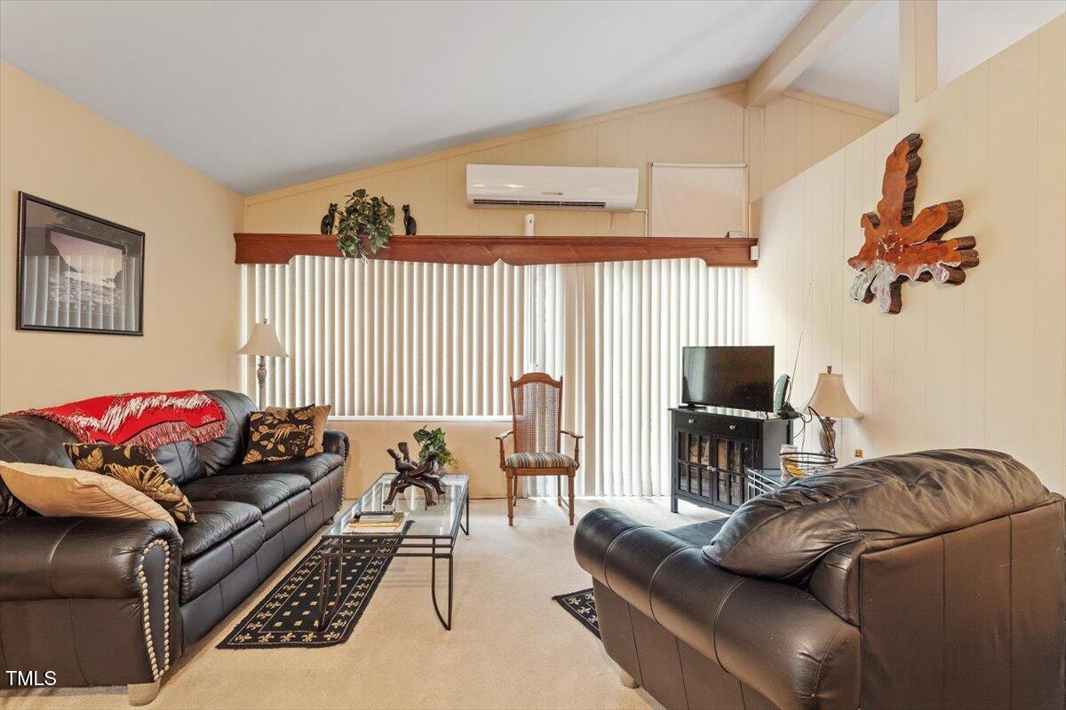 911 Williams Road Raleigh, NC 27610 - Photo 19 of 33 a living room with furniture and a flat screen tv