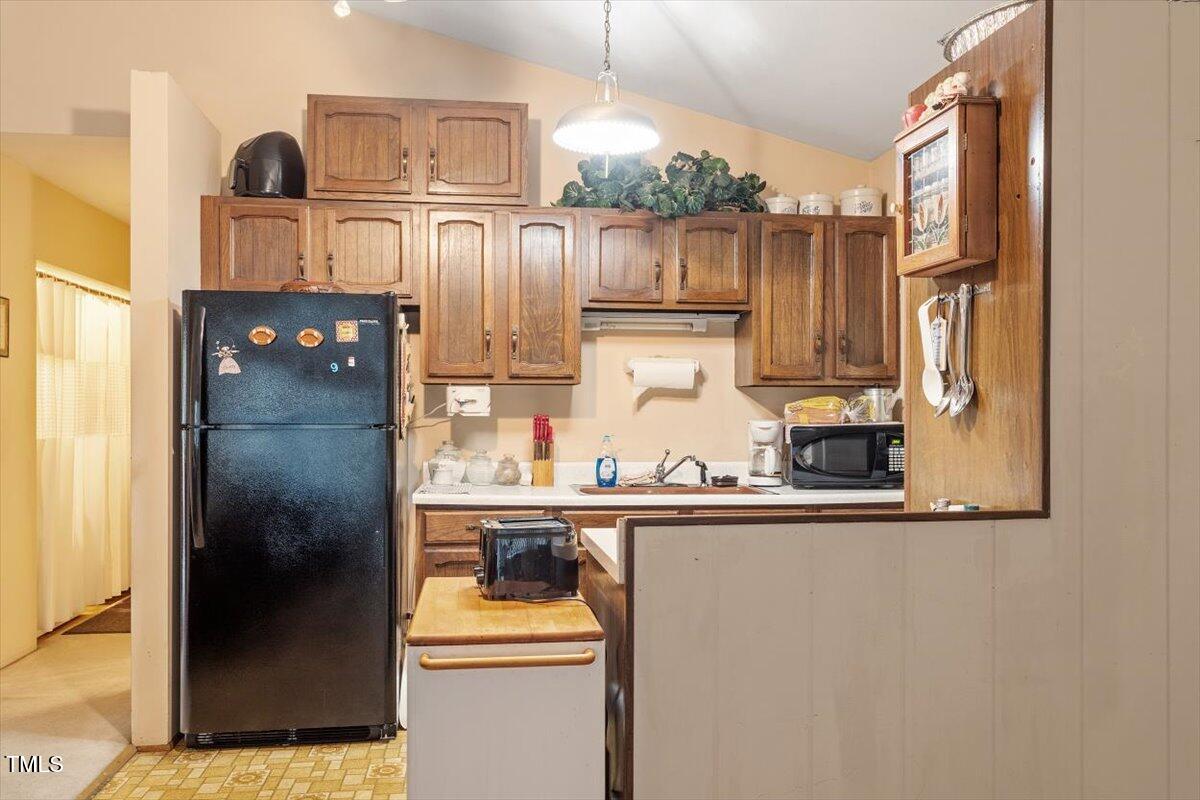 911 Williams Road Raleigh, NC 27610 - Photo 22 of 33 a kitchen with stainless steel appliances granite countertop a refrigerator and a stove