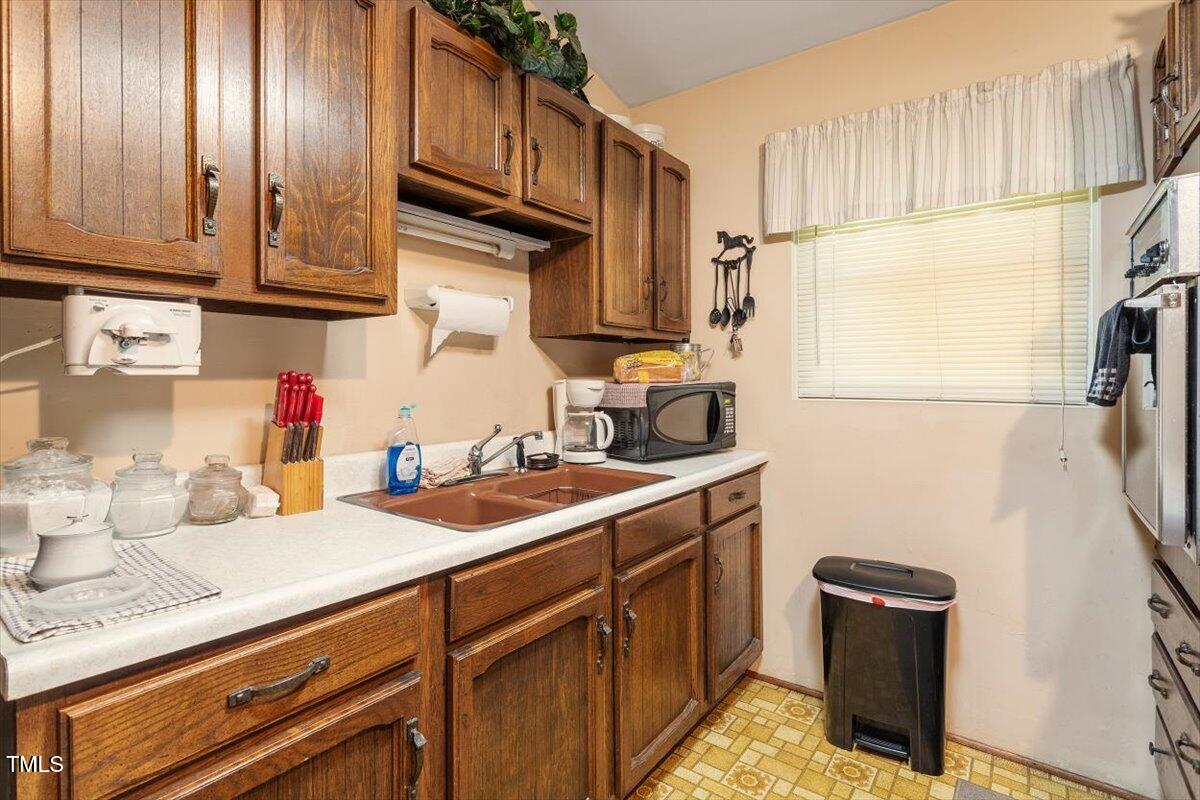 911 Williams Road Raleigh, NC 27610 - Photo 23 of 33 a kitchen with stainless steel appliances granite countertop a sink stove and cabinets