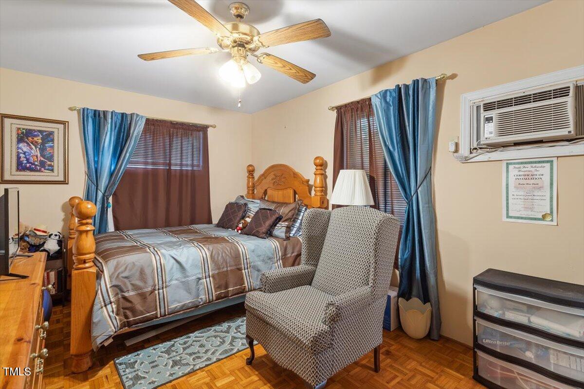911 Williams Road Raleigh, NC 27610 - Photo 28 of 33 a bedroom with a bed wooden floor and window