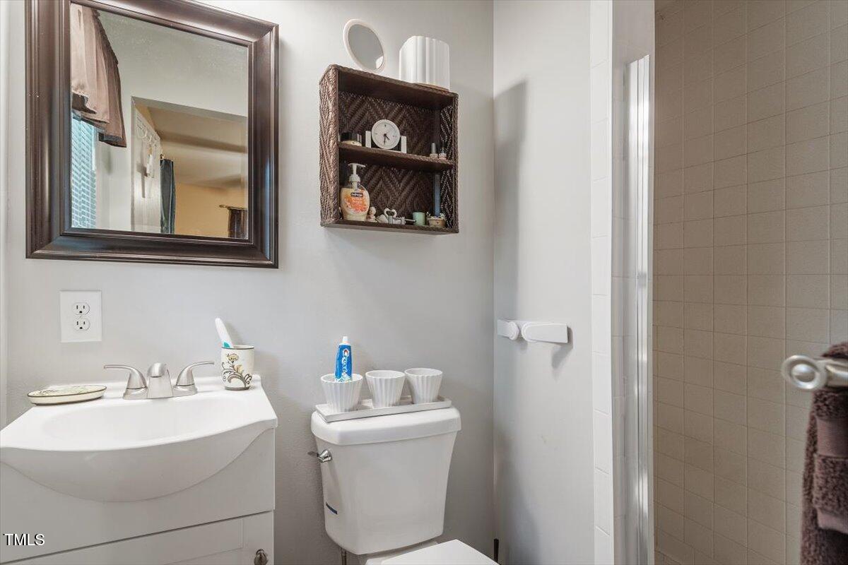 911 Williams Road Raleigh, NC 27610 - Photo 31 of 33 a bathroom with a toilet a sink and mirror
