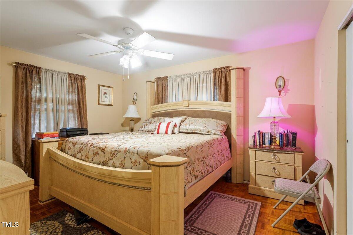 911 Williams Road Raleigh, NC 27610 - Photo 32 of 33 a bedroom with a bed and a chandelier