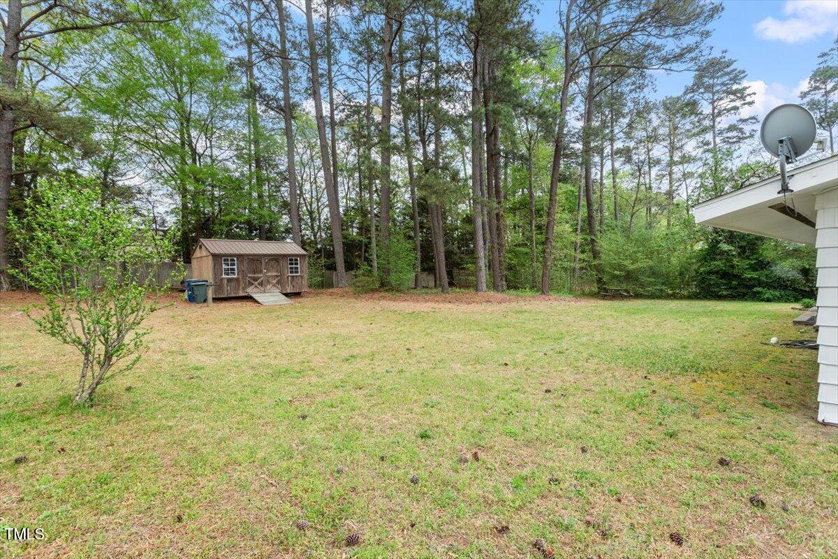 911 Williams Road Raleigh, NC 27610 - Photo 6 of 33 a backyard of a house with table and chairs