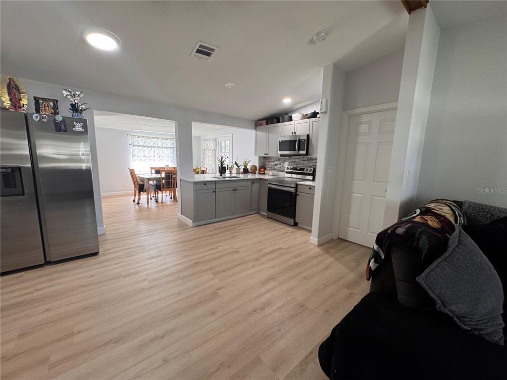 125 Ridgewood Drive Arcadia, FL 34266 - Photo 11 of 31 a kitchen with stainless steel appliances kitchen island granite countertop a refrigerator a stove a microwave oven a sink with island and chairs