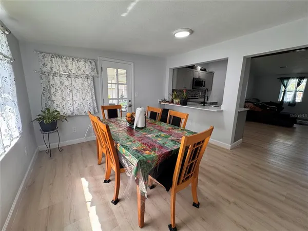 a dining room with furniture window and wooden floor