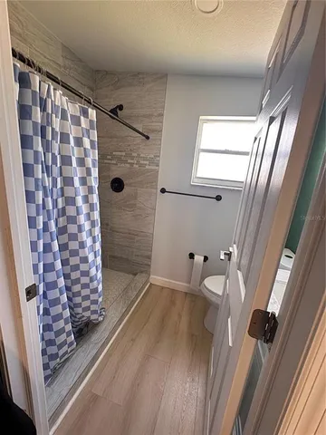 a bathroom with a toilet and a shower