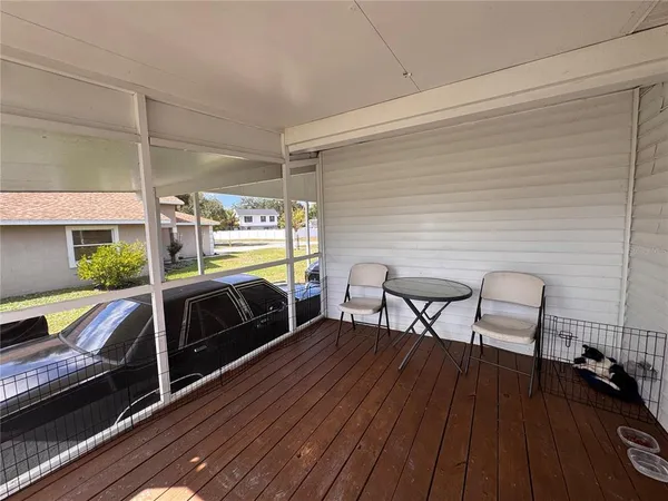 a view of a chairs and table in the balcony