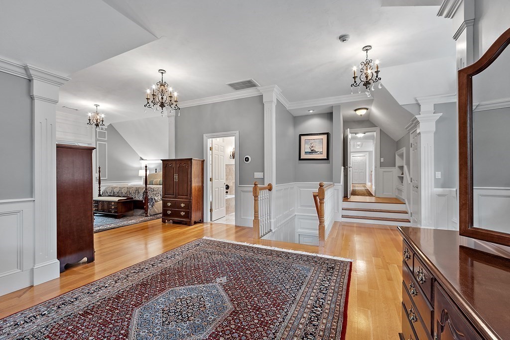 106 Fox Run Road Bolton, MA 01740 - Photo 21 of 41 a view of a hallway with a dining table and chandelier