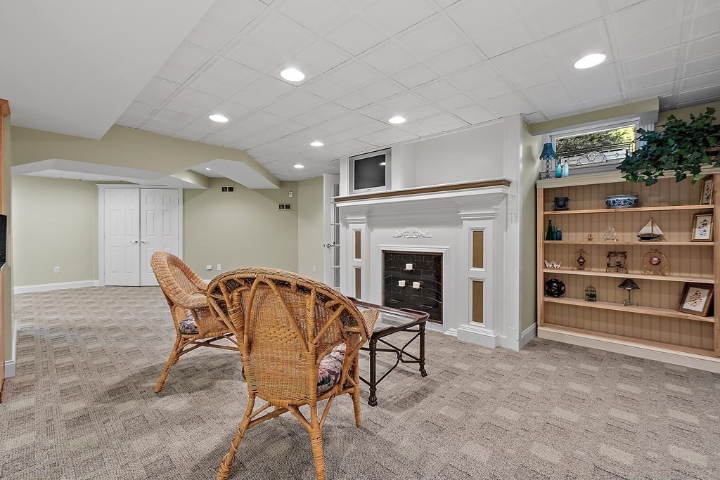 106 Fox Run Road Bolton, MA 01740 - Photo 37 of 41 a dining room with furniture and a fireplace