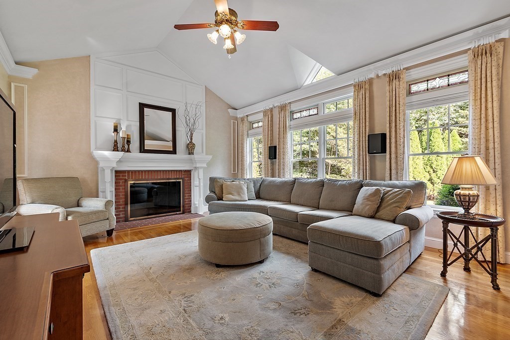 106 Fox Run Road Bolton, MA 01740 - Photo 10 of 41 a living room with furniture a large window and a fireplace