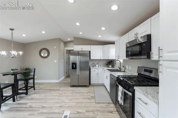 a large kitchen with a table and chairs in it