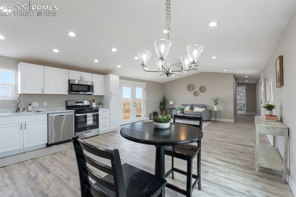 6190 Night Train Lane Yoder, CO 80864 - Photo 16 of 35 a large kitchen with a table and chairs in it