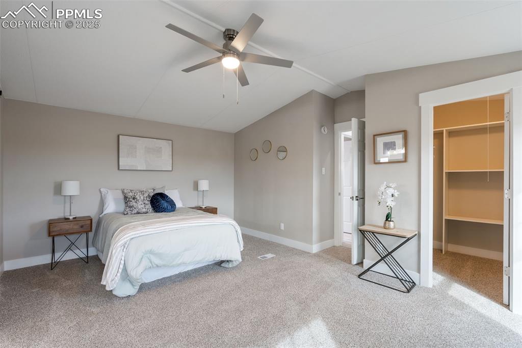 6190 Night Train Lane Yoder, CO 80864 - Photo 20 of 35 a bedroom with a bed and a chandelier
