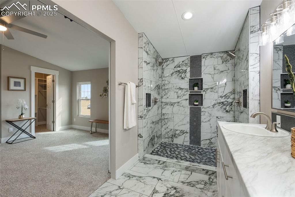 6190 Night Train Lane Yoder, CO 80864 - Photo 25 of 35 a bathroom with a granite countertop shower a sink and a mirror