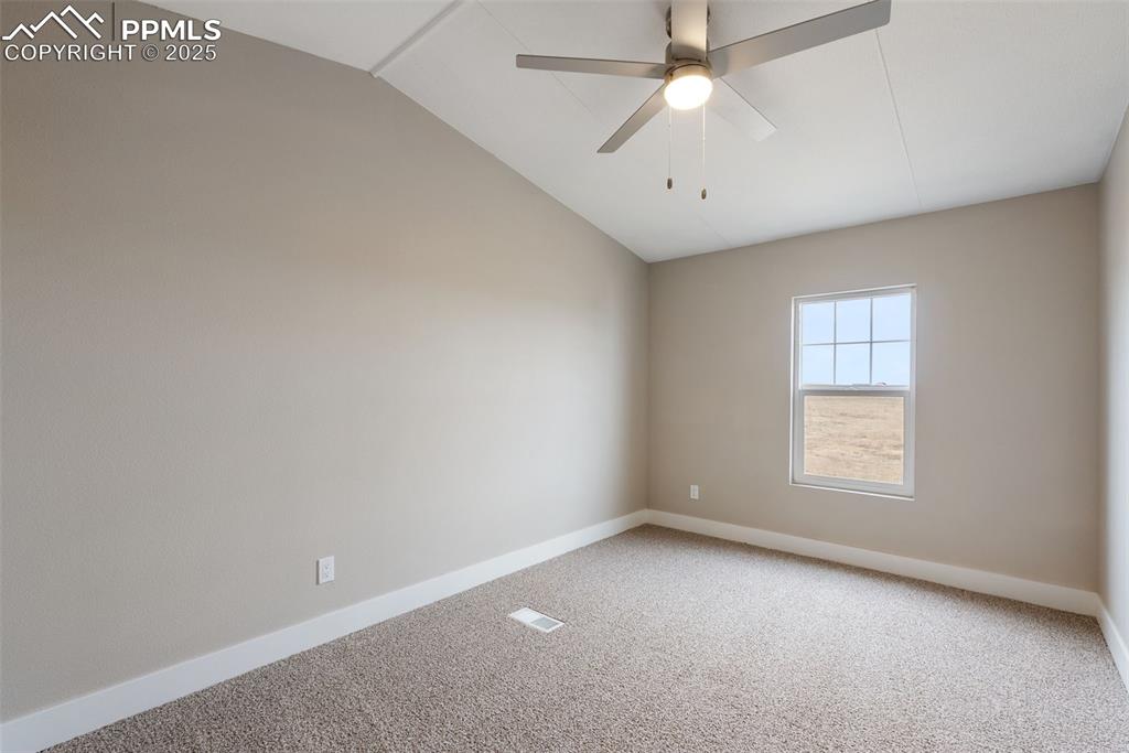 6190 Night Train Lane Yoder, CO 80864 - Photo 26 of 35 an empty room with a window and a ceiling fan