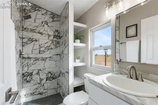 a view of a house with wooden fence