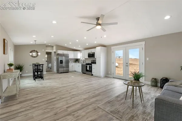a living room with furniture and a large window