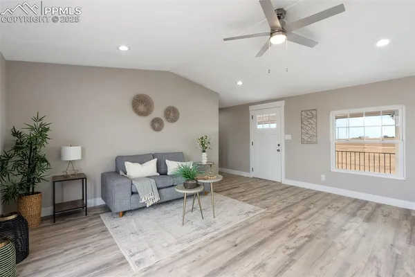 a living room with furniture and wooden floor